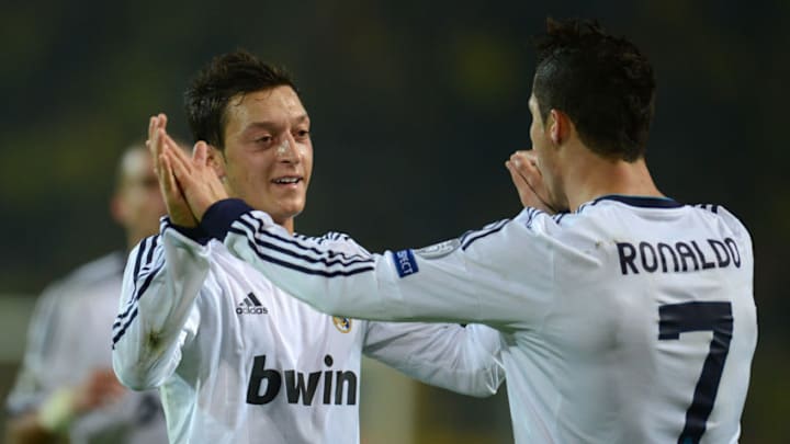 Real Madrid's Portuguese forward Cristiano Ronaldo (R) celebrates scoring the 1-1 equalizer with German teammate midfielder Mesut Ozil during the UEFA Champions League Group D football match BVB Borussia Dortmund vs Real Madrid in Dortmund, western Germany on October 24, 2012. AFP PHOTO / PATRIK STOLLARZ (Photo credit should read PATRIK STOLLARZ/AFP/Getty Images)