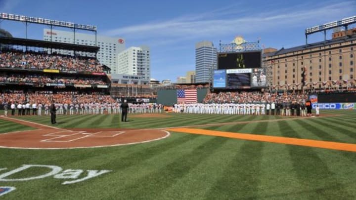 Mar 31, 2014; Baltimore, MD, USA; General view of the Boston Red Sox and the Baltimore Orioles lining the bases before an opening day game at Oriole Park at Camden Yards. Mandatory Credit: Joy R. Absalon-USA TODAY Sports