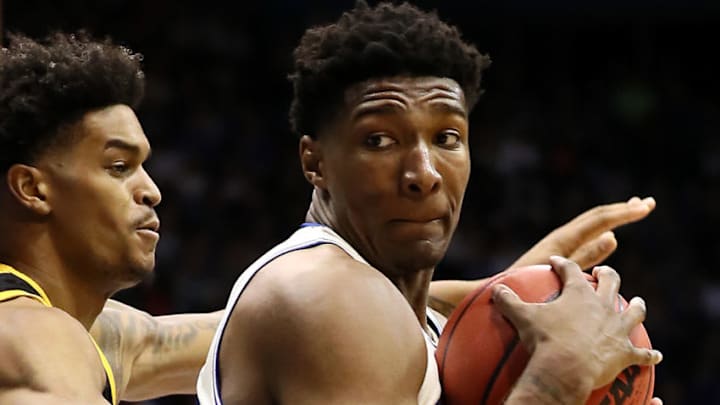 LAWRENCE, KANSAS - DECEMBER 10: David McCormack #33 of the Kansas Jayhawks controls the ball as Wil Sessoms #4 of the Milwaukee Panthers defends during the game at Allen Fieldhouse on December 10, 2019 in Lawrence, Kansas. (Photo by Jamie Squire/Getty Images)