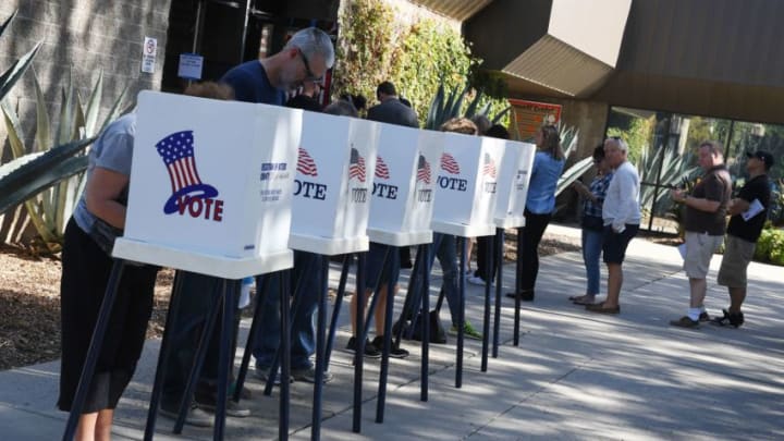 People vote at outdoor booths during early voting for the mid-term elections in Pasadena, California on November 3, 2018. (Photo by Mark RALSTON / AFP) (Photo credit should read MARK RALSTON/AFP/Getty Images)