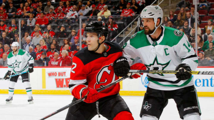 NEWARK, NJ - OCTOBER 16: Ben Lovejoy #12 of the New Jersey Devils in action against Jamie Benn #14 of the Dallas Stars at Prudential Center on October 16, 2018 in Newark, New Jersey. The Devils defeated the Stars 3-0. (Photo by Jim McIsaac/Getty Images)