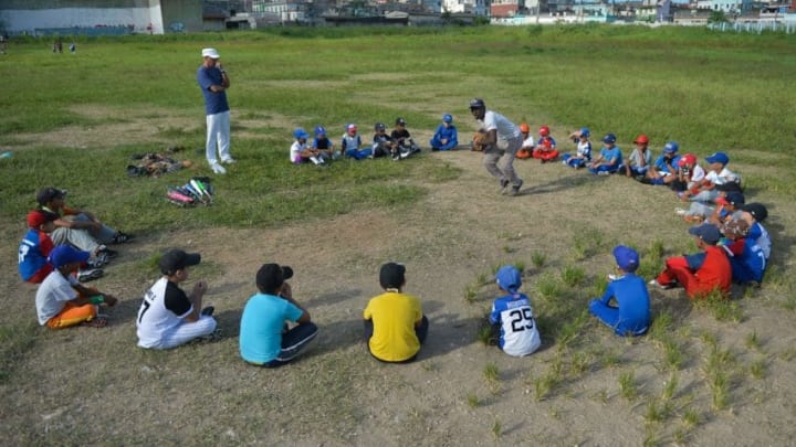 Cuban children attend a baseball class in a field of Havana, on September 17, 2018. - Football took over baseball in the preference of children and young people in Cuba, where the latter has been king for almost 150 years. (Photo by Yamil LAGE / AFP) (Photo credit should read YAMIL LAGE/AFP via Getty Images)