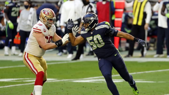 GLENDALE, ARIZONA – JANUARY 03: Offensive tackle Mike McGlinchey #69 of the San Francisco 49ers defends linebacker K.J. Wright #50 of the Seattle Seahawks during the first half at State Farm Stadium on January 03, 2021 in Glendale, Arizona. (Photo by Chris Coduto/Getty Images)