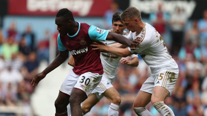 LONDON, ENGLAND - MAY 07: Stephen Kingsley of Swansea City tries to tackle Michail Antonio of West Ham during the Barclays Premier League match between West Ham United and Swansea City at the Boleyn Ground, May 7, 2016, London, England. (Photo by Ian Walton/Getty Images)