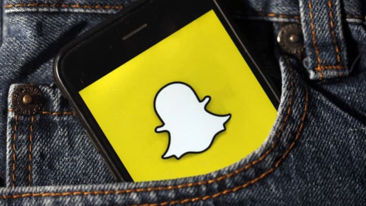 In this photo illustration, the Snapchat application logo is displayed on the screen of a smartphone (Photo by Chesnot/Getty Images)