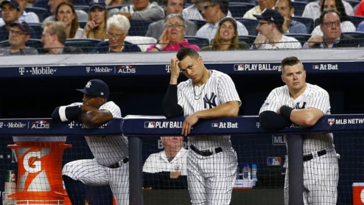 NEW YORK, NEW YORK – OCTOBER 09: Andrew McCutchen #26, Giancarlo Stanton #27 and Luke Voit #45 of the New York Yankees looks on from the dugout against the Boston Red Sox in Game Four of the American League Division Series at Yankee Stadium on October 09, 2018 in the Bronx borough of New York City. (Photo by Mike Stobe/Getty Images)