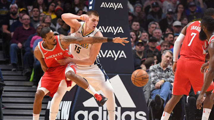 DENVER, CO - FEBRUARY 25: Forward Trevor Ariza #1 of the Houston Rockets and center Nikola Jokic #15 of the Denver Nuggets compete for a rebound at Pepsi Center on February 25, 2018 in Denver, Colorado. NOTE TO USER: User expressly acknowledges and agrees that, by downloading and or using this photograph, User is consenting to the terms and conditions of the Getty Images License Agreement. (Photo by Justin Tafoya/Getty Images)