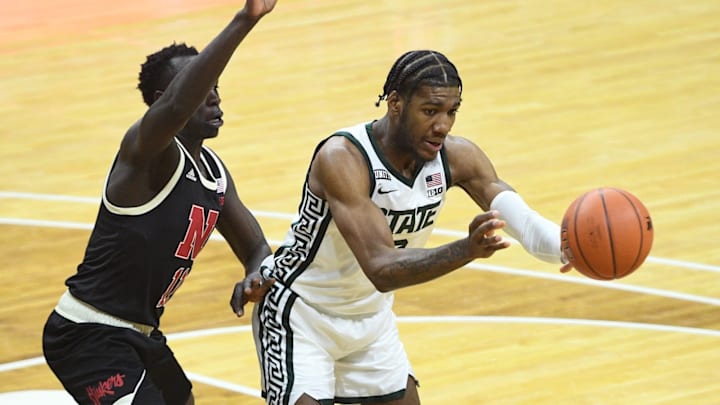 Feb 6, 2021; East Lansing, Michigan, USA; Michigan State Spartans forward Aaron Henry (0) passes as Nebraska Cornhuskers forward Lat Mayen (11) defends during the second half at Jack Breslin Student Events Center. Mandatory Credit: Tim Fuller-USA TODAY Sports