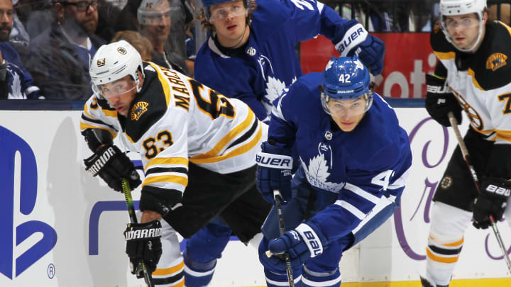 TORONTO, ON - OCTOBER 19: Brad Marchand #63 of the Boston Bruins battles against Trevor Moore #42 of the Toronto Maple Leafs during an NHL game at Scotiabank Arena on October 19, 2019 in Toronto, Ontario, Canada. The Maple Leafs defeated the Bruins 4-3 in overtime. (Photo by Claus Andersen/Getty Images)