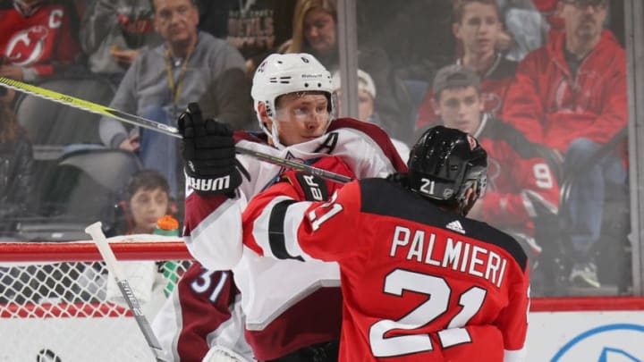 NEWARK, NEW JERSEY - OCTOBER 18: Erik Johnson #6 of the Colorado Avalanche defends against Kyle Palmieri #21 of the New Jersey Devils during the second period at the Prudential Center on October 18, 2018 in Newark, New Jersey. (Photo by Bruce Bennett/Getty Images)