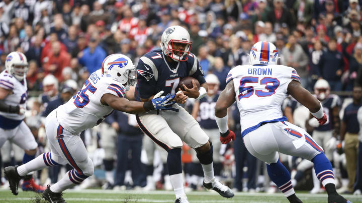 FOXBORO, MA – OCTOBER 2:  Jacoby Brissett #7 of the New England Patriots is wrapped up by Jerry Hughes #55 and Zach Brown #53 of the Buffalo Bills in the second quarter at Gillette Stadium on October 2, 2016 in Foxboro, Massachusetts. Brissett fumbled on the play, and the ball was recovered by the Bills. (Photo by Kevin Sabitus/Getty Images)