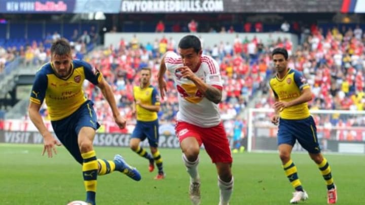 Jul 26, 2014; Harrison, NJ, USA; New York Red Bulls midfielder Tim Cahill (17) controls the ball between Arsenal defender Carl Jenkinson (25) and Arsenal midfielder Mikel Arteta (8) during the first half of a game at Red Bull Arena. Mandatory Credit: Brad Penner-USA TODAY Sports