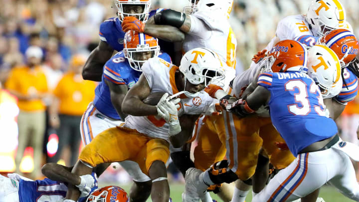 Florida Gators defensive lineman Princely Umanmielen (33) grabs the facemask of Tennessee Volunteers running back Tiyon Evans (8) as he tackles during the football game between the Florida Gators and Tennessee Volunteers, at Ben Hill Griffin Stadium in Gainesville, Fla. Sept. 25, 2021.Flgai 092521 Ufvs Tennesseefb 44