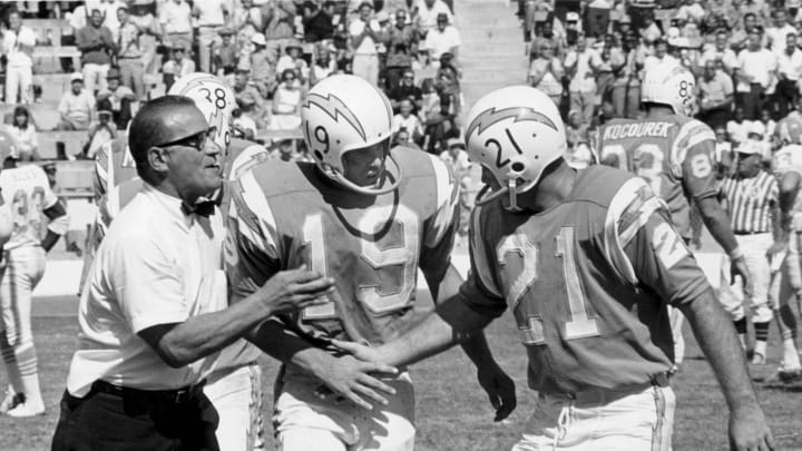 San Diego Chargers head coach Sid Gillman congratulates flanker Lance Alworth (19) and quarterback John Hadl (21) following a 31-14 victory over the Houston Oilers on October 3, 1965, at Balboa Stadium in San Diego, California. (Photo by Charles Aqua Viva/Getty Images)