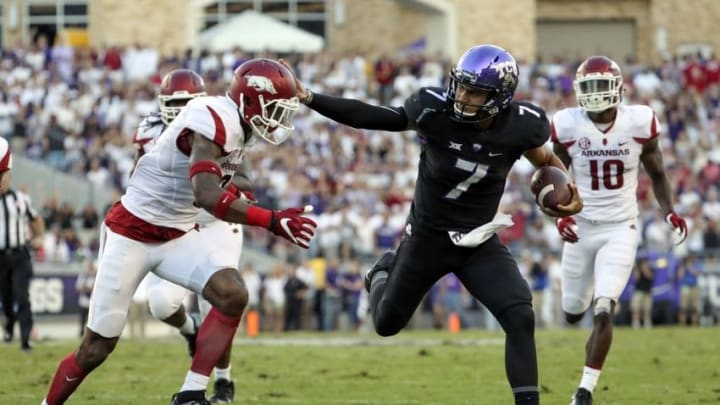 Sep 10, 2016; Fort Worth, TX, USA; TCU Horned Frogs quarterback Kenny Hill (7) stiff arms Arkansas Razorbacks defensive back Santos Ramirez (9) during the first half at Amon G. Carter Stadium. Mandatory Credit: Kevin Jairaj-USA TODAY Sports
