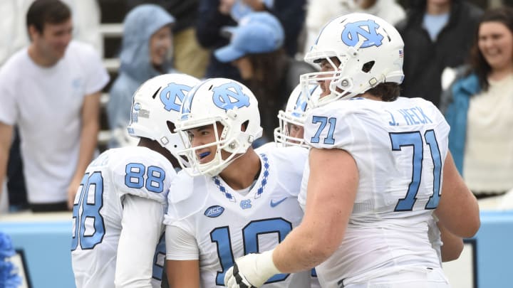Sep 26, 2015; Chapel Hill, NC, USA; North Carolina Tar Heels quarterback Mitch Trubisky (10) celebrates in the end zone with wide receiver Jordan Fieulleteau (88) and offensive tackle Jon Heck (71) after throwing a touchdown pass to wide receiver Ryan Switzer (3) (not pictured) in the fourth quarter. The Tar Heels defeated the Delaware Fightin Blue Hens 41-14 at Kenan Memorial Stadium. Mandatory Credit: Bob Donnan-USA TODAY Sports