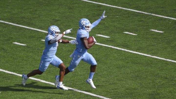 Oct 24, 2020; Chapel Hill, North Carolina, USA; North Carolina Tar Heels defensive back Don Chapman (2) celebrates with defensive back Trey Morrison (4) after intercepting a pass in the end zone intended in the second quarter at Kenan Memorial Stadium. Mandatory Credit: Bob Donnan-USA TODAY Sports