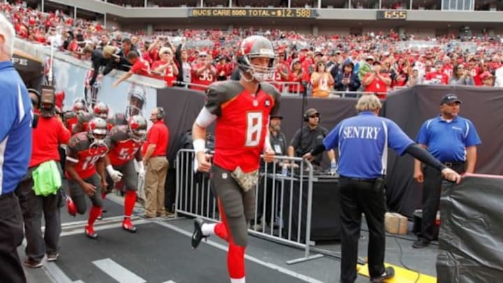 Nov 9, 2014; Tampa, FL, USA; Tampa Bay Buccaneers quarterback Mike Glennon (8) and teammates run out of the tunnel before the game against the Atlanta Falcons at Raymond James Stadium. Mandatory Credit: Kim Klement-USA TODAY Sports