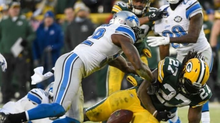 Dec 28, 2014; Green Bay, WI, USA; Green Bay Packers running back Eddie Lacy (27) fumbles the ball after a tackle by Detroit Lions safety James Ihedigbo (32) in the second quarter at Lambeau Field. Mandatory Credit: Benny Sieu-USA TODAY Sports
