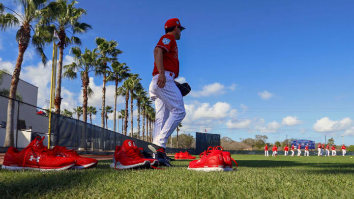 Feb 21, 2019; Clearwater, FL, USA; Philadelphia Phillies coach Sam Fuld (87) walks through shoes from players during spring training at Spectrum Field. Mandatory Credit: Butch Dill-USA TODAY Sports