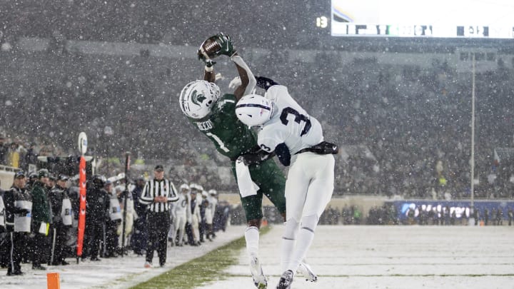 Nov 27, 2021; East Lansing, Michigan, USA; Michigan State Spartans wide receiver Jayden Reed (1) makes a touchdown catch against Penn State Nittany Lions cornerback Johnny Dixon (3) during the fourth quarter at Spartan Stadium. Mandatory Credit: Raj Mehta-USA TODAY Sports