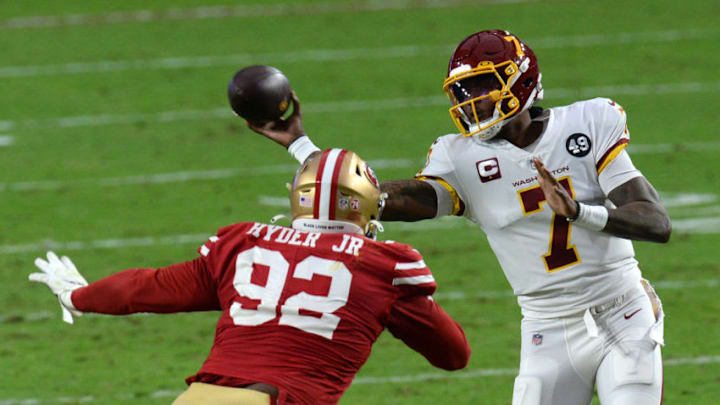 Dec 13, 2020; Glendale, Arizona, USA; Washington Football Team quarterback Dwayne Haskins (7) throws a pass against San Francisco 49ers defensive end Kerry Hyder (92) during the second half at State Farm Stadium. Mandatory Credit: Joe Camporeale-USA TODAY Sports