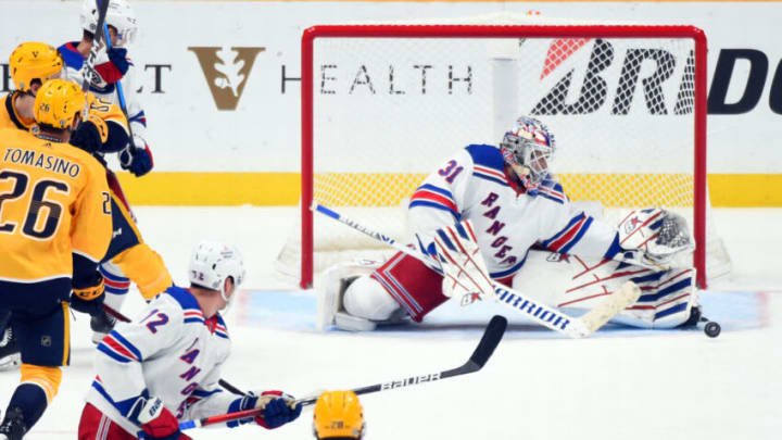 Oct 21, 2021; Nashville, Tennessee, USA; New York Rangers goaltender Igor Shesterkin (31) makes a save during the second period against the Nashville Predators at Bridgestone Arena. Mandatory Credit: Christopher Hanewinckel-USA TODAY Sports