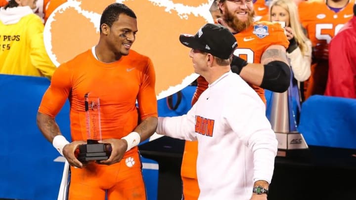 Dec 5, 2015; Charlotte, NC, USA; Game MVP and Clemson Tigers quarterback Deshaun Watson (4) talks to Clemson Tigers head coach Dabo Swinney (R) during the fourth quarter in the ACC football championship game at Bank of America Stadium. The Tigers won 45-37. Mandatory Credit: Jim Dedmon-USA TODAY Sports