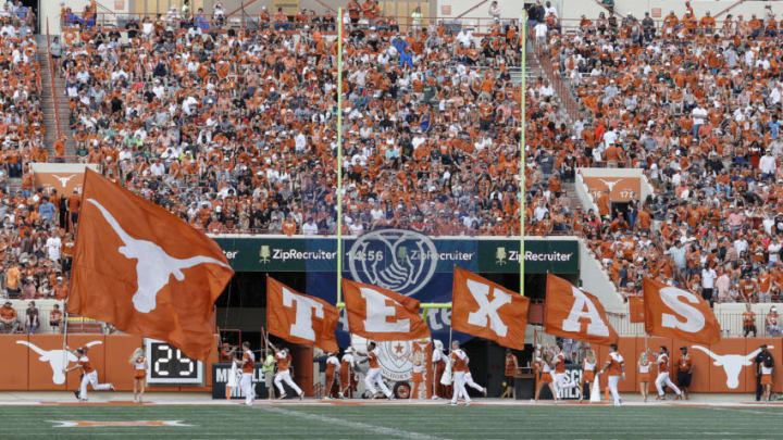 AUSTIN, TX - OCTOBER 13: The Texas Longhorns cheerleaders run with flags after a touchdown in the second half against the Baylor Bears at Darrell K Royal-Texas Memorial Stadium on October 13, 2018 in Austin, Texas. (Photo by Tim Warner/Getty Images)