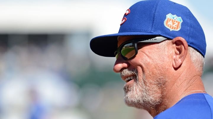 Mar 16, 2016; Surprise, AZ, USA; Chicago Cubs manager Joe Maddon (70) smiles after starting pitcher John Lackey (not pictured) picked off Kansas City Royals center fielder Reymond Fuentes (not pictured) during the fifth inning at Surprise Stadium. Mandatory Credit: Jake Roth-USA TODAY Sports