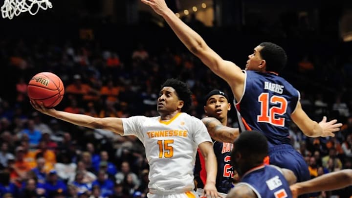 Mar 9, 2016; Nashville, TN, USA; Tennessee Volunteers guard Detrick Mostella (15) shoots the ball between Auburn Tigers forward Jordon Granger (25) and forward Tyler Harris (12) during game one of the SEC Tournament at Bridgestone Arena. Mandatory Credit: Joshua Lindsey-USA TODAY Sports