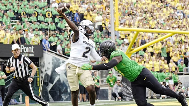 Sep 23, 2023; Eugene, Oregon, USA; Colorado Buffaloes quarterback Shedeur Sanders (2) throws a pass while under pressure from Oregon Ducks linebacker Blake Purchase (17) during the first half at Autzen Stadium. Mandatory Credit: Soobum Im-USA TODAY Sports
