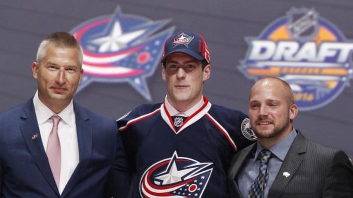 Jun 24, 2016; Buffalo, NY, USA; Pierre-Luc Dubois poses for a photo with team officials after being selected as the number three overall draft pick by the Columbus Blue Jackets in the first round of the 2016 NHL Draft at the First Niagra Center. Mandatory Credit: Timothy T. Ludwig-USA TODAY Sports