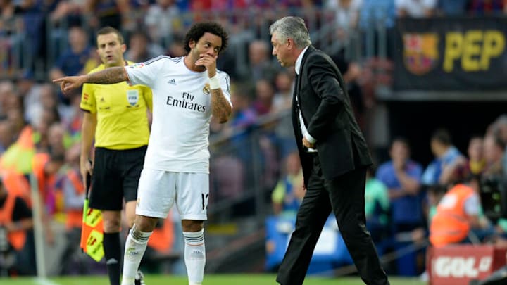 Real Madrid’s Brazilian defender Marcelo (L) talks with Real Madrid’s Italian coach Carlo Ancelotti (Photo credit should read LLUIS GENE/AFP via Getty Images)