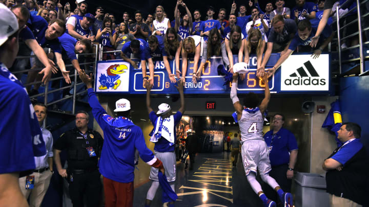 LAWRENCE, KS – FEBRUARY 22: Malik Newman #14, Carlton Bragg Jr. #15 and Devonte’ Graham #4 of the Kansas Jayhawks celebrate with fans after clinching their 13th straight Big 12 Conference Championship title with a 87-68 win over the TCU Horned Frogs at Allen Fieldhouse on February 22, 2017 in Lawrence, Kansas. (Photo by Ed Zurga/Getty Images)