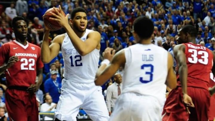 Mar 15, 2015; Nashville, TN, USA; Kentucky Wildcats forward Karl-Anthony Towns (12) keeps the ball away from Arkansas Razorbacks forward Jacorey Williams (22) during the second half of the SEC Conference championship game at Bridgestone Arena. Kentucky Wildcats defeated Arkansas Razorbacks 78-63. Mandatory Credit: Joshua Lindsey-USA TODAY Sports