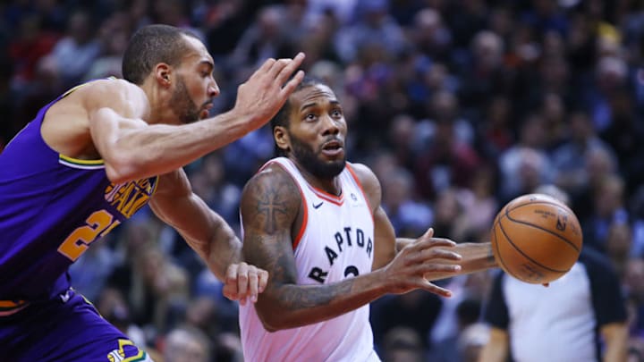 TORONTO, ON - JANUARY 1: Kawhi Leonard #2 of the Toronto Raptors dribbles the ball as Rudy Gobert #27 of the Utah Jazz defends during the first half of an NBA game at Scotiabank Arena on January 1, 2019 in Toronto, Canada. NOTE TO USER: User expressly acknowledges and agrees that, by downloading and or using this photograph, User is consenting to the terms and conditions of the Getty Images License Agreement. (Photo by Vaughn Ridley/Getty Images)