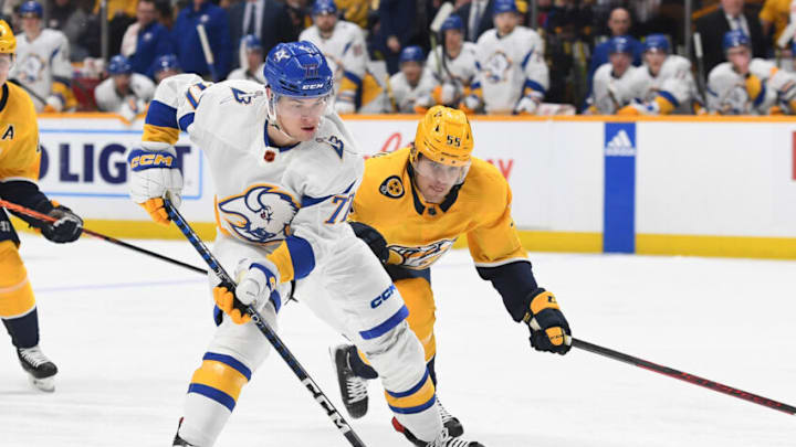 Jan 14, 2023; Nashville, Tennessee, USA; Buffalo Sabres right wing JJ Peterka (77) skates with the puck against Nashville Predators defenseman Roland McKeown (55) during the second period at Bridgestone Arena. Mandatory Credit: Christopher Hanewinckel-USA TODAY Sports