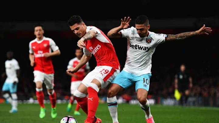 LONDON, ENGLAND - APRIL 05: Granit Xhaka of Arsenal (L) and Manuel Lanzini of West Ham United (R) battle for possession during the Premier League match between Arsenal and West Ham United at the Emirates Stadium on April 5, 2017 in London, England. (Photo by Dan Mullan/Getty Images)