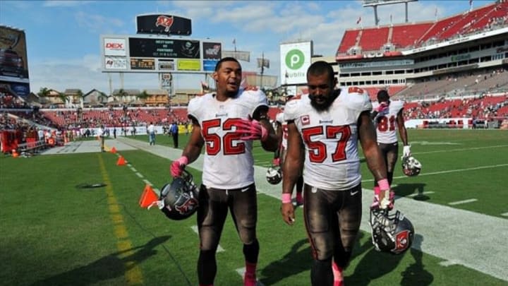 Oct 13, 2013; Tampa, FL, USA; Tampa Bay Buccaneers outside linebacker Jonathan Casillas (left) and Tampa Bay Buccaneers outside linebacker Adam Hayward (right) both walk off the field after losing to the Philadelphia Eagles 31-20 at Raymond James Stadium. Mandatory Credit: Steve Mitchell-USA TODAY Sports