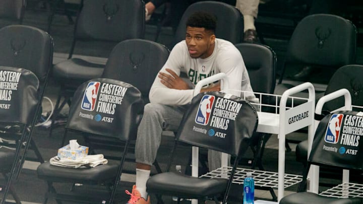 Jul 1, 2021; Milwaukee, Wisconsin, USA; Milwaukee Bucks forward Giannis Antetokounmpo sits on the sidelines during warmups before game five of the Eastern Conference Finals against the Atlanta Hawks during the 2021 NBA Playoffs at Fiserv Forum. Mandatory Credit: Jeff Hanisch-USA TODAY Sports