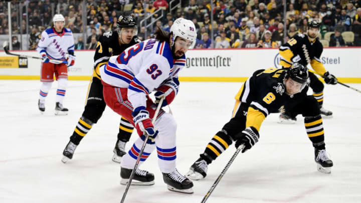 PITTSBURGH, PENNSYLVANIA - FEBRUARY 26: Mika Zibanejad #93 of the New York Rangers controls the puck against Brian Dumoulin #8 of the Pittsburgh Penguins during the first period at PPG PAINTS Arena on February 26, 2022 in Pittsburgh, Pennsylvania. (Photo by Emilee Chinn/Getty Images)