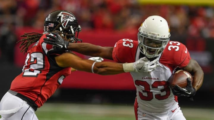 Nov 27, 2016; Atlanta, GA, USA; Arizona Cardinals running back Kerwynn Williams (33) tries to break free from Atlanta Falcons cornerback Jalen Collins (32) during the second quarter at the Georgia Dome. Mandatory Credit: Dale Zanine-USA TODAY Sports