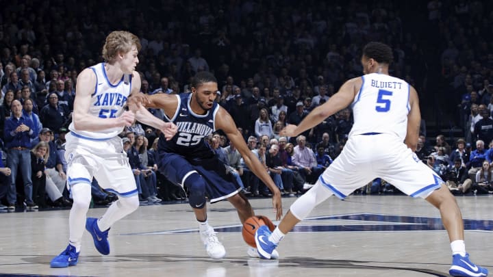CINCINNATI, OH – FEBRUARY 17: Mikal Bridges #25 of the Villanova Wildcats handles the ball while defended by J.P. Macura #55 and Trevon Bluiett #5 of the Xavier Musketeers during a game at Cintas Center on February 17, 2018 in Cincinnati, Ohio. Villanova won 95-79. (Photo by Joe Robbins/Getty Images)