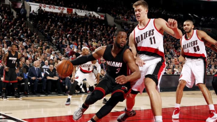 Dwyane Wade #3 of the Miami Heat drives against Meyers Leonard #11 (Photo by Cameron Browne/NBAE via Getty Images)