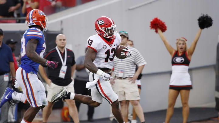 JACKSONVILLE, FL – OCTOBER 28: Elijah Holyfield #13 of the Georgia Bulldogs runs for a 39-yard touchdown in the fourth quarter of a game against the Florida Gators at EverBank Field on October 28, 2017, in Jacksonville, Florida. Georgia defeated Florida 42-7. (Photo by Joe Robbins/Getty Images)