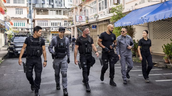 “Thai Hard” – During a trip to Bangkok to train alongside Thailand’s premiere S.W.A.T. team, Hondo and his former military buddy Joe (guest star Sean Maguire) stumble upon a wide-ranging heroin operation with ties to Los Angeles and find themselves on the run from a powerful drug kingpin, on the season premiere of S.W.A.T., Friday, Oct. 7 (8:00-9:00 PM, ET/PT) on the CBS Television Network and available to stream live and on demand on Paramount+. Pictured (L-R): David Lim as Victor Tan, Jay Harrington as David “Deacon” Kay and Shemar Moore as Daniel “Hondo” Harrelson. Photo: Jack Taylor/CBS ©2022 CBS Broadcasting, Inc. All Rights Reserved.