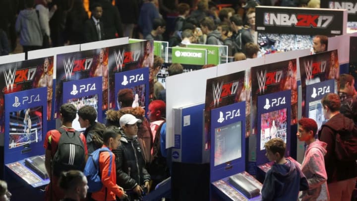 PARIS, FRANCE - OCTOBER 27: Gamers play the video game "WWE 2K17" developed by Visual Concepts and Yuke's and published by 2K Sports during the "Paris Games Week" on October 27, 2016 in Paris, France. "Paris Games Week is an international trade fair for video games to be held from October 26 to October 31, 2016. (Photo by Chesnot/Getty Images)