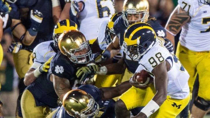 Sep 6, 2014; South Bend, IN, USA; Michigan Wolverines quarterback Devin Gardner (98) is sacked by Notre Dame Fighting Irish linebacker Kolin Hill (43) defensive lineman Justin Utupo (53) and cornerback Matthias Farley (41) in the fourth quarter at Notre Dame Stadium. Notre Dame won 31-0. Mandatory Credit: Matt Cashore-USA TODAY Sports