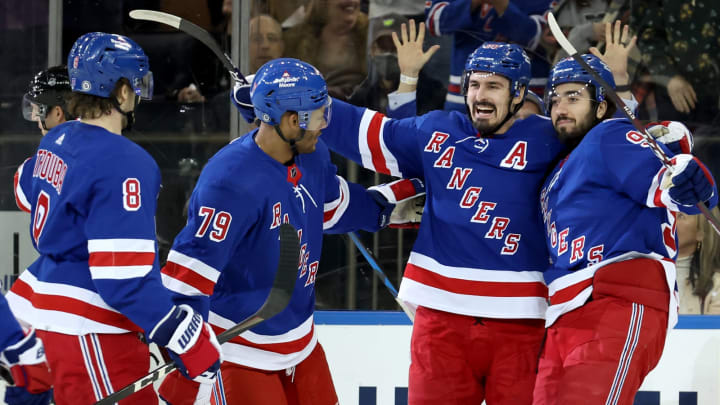 Mar 25, 2022; New York, New York, USA; New York Rangers left wing Chris Kreider (20) celebrates his goal against the Pittsburgh Penguins with defenseman Jacob Trouba (8) and defenseman K’Andre Miller (79) and center Mika Zibanejad (93) during the first period at Madison Square Garden. Mandatory Credit: Brad Penner-USA TODAY Sports
